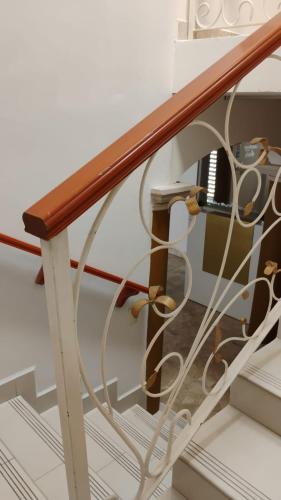 a stairway with a wooden railing and a wooden rail at Cumbresuites in Monterrey