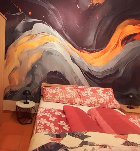 a bedroom with a painting on the wall at Ferienappartement in der Spielestadt in Ravensburg