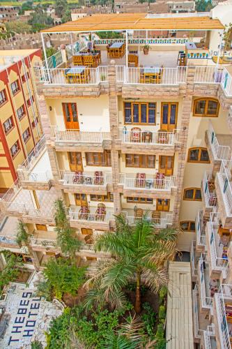 an aerial view of an apartment building with palm trees at Thebes Hotel in Luxor