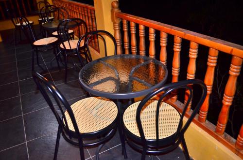 a table and chairs sitting on a balcony at Monteverde Best Inn - CASAS QUINTAS in Tenza