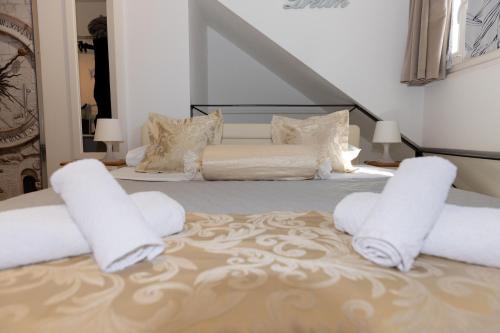 a bedroom with a bed with white pillows at Central Split rooms and apartments Paese in Split