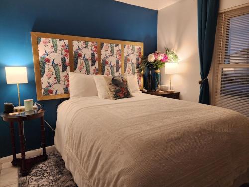 a bedroom with a large bed with a blue wall at 3BR Oasis with Pool in Cocoa in Cocoa