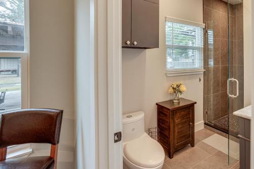 a bathroom with a toilet and a glass shower at Pets Welcome Home with Deck and Patio in Hockley! in Hockley