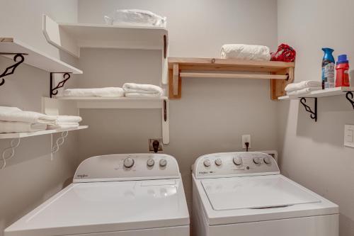 a small laundry room with a washer and dryer at Pets Welcome Home with Deck and Patio in Hockley! in Hockley
