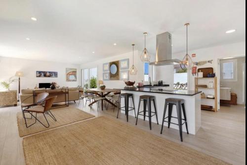 a kitchen and living room with a table and chairs at Olive Tree House by DolceStay in Sesimbra
