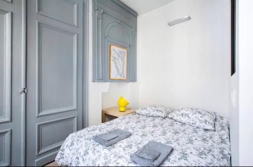 une chambre avec un lit avec deux serviettes dessus dans l'établissement Charmant Appartement au cœur du Vieux-Lille, à Lille
