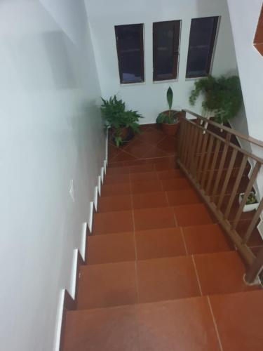 a staircase leading to the second floor of a house at De Pina Apartments in Pedra Badejo