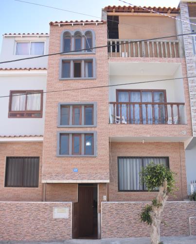a brick building with windows and a balcony at De Pina Apartments in Pedra Badejo