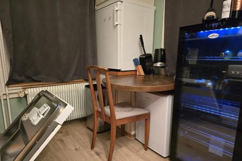 a small kitchen with a small table and a refrigerator at Villa de Maître in Bern in Bern