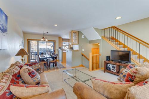 a living room with a couch and a tv at Airy Winter Park Gem with Private Outdoor Hot Tub! in Winter Park