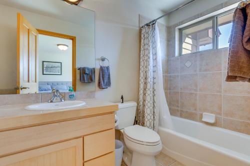 a bathroom with a sink and a toilet and a tub at Airy Winter Park Gem with Private Outdoor Hot Tub! in Winter Park