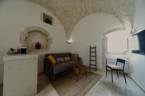 a living room with a couch and a table at Suite Dimora Antico Campanile in Locorotondo