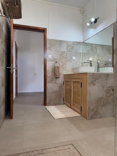 a bathroom with a sink and a mirror at Equinox Appartment in La Gaulette