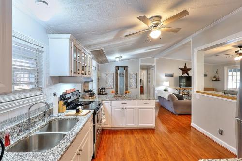 a kitchen with white cabinets and a ceiling fan at Lake Oconee Stunning views, deep water oversized dock, fully renovated in Eatonton