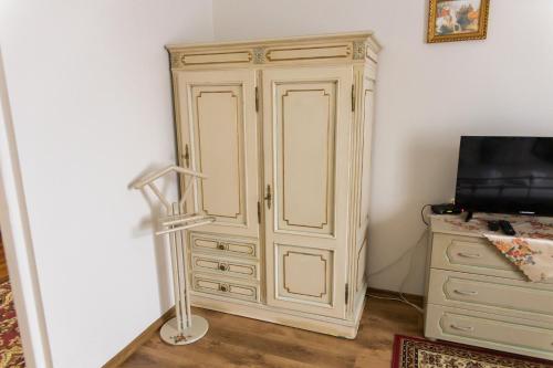 a large white cabinet in a room with a television at Hotel Napoleon in Wróblew