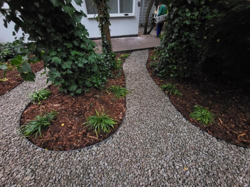 a garden with a stone walkway with plants at Prawdziwa Jurata in Jurata