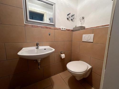 a bathroom with a sink and a toilet at Endbach-Life in Bad Endbach