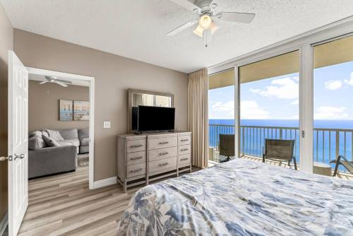 a bedroom with a bed and a flat screen tv at Majestic Beach Resort 1404 in Panama City Beach