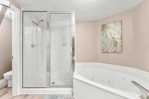 a white bathroom with a tub and a shower at Majestic Beach Resort 1404 in Panama City Beach