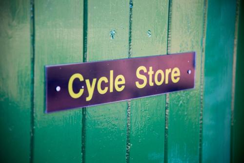 a sign that says cycle store on a wooden door at Ingleton Hostel in Ingleton 