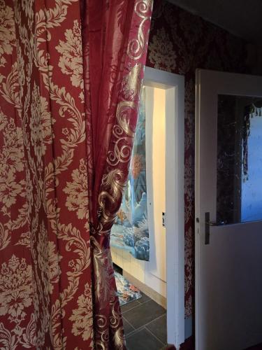 a red curtain in a room with a window at Villa de Maître in Bern in Bern