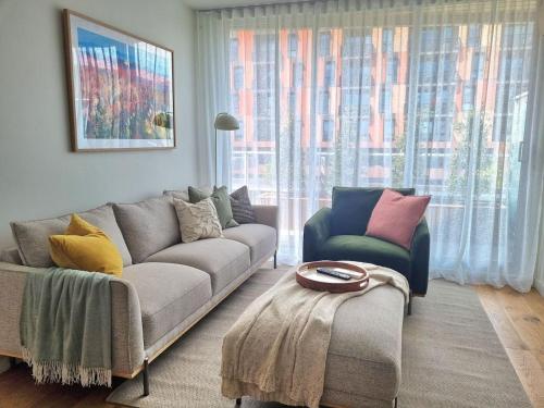 a living room with a couch and two chairs at Regent Retreat Top floor apartment in Melbourne