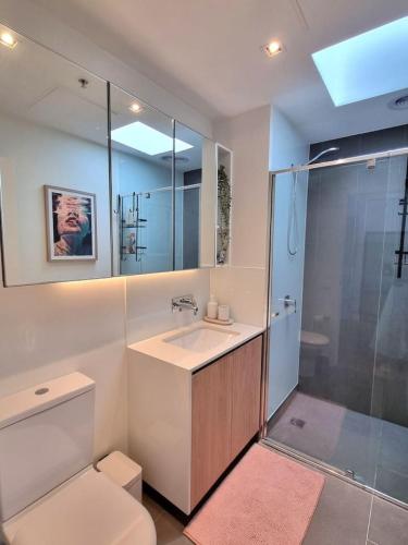 a bathroom with a toilet and a sink and a shower at Regent Retreat Top floor apartment in Melbourne