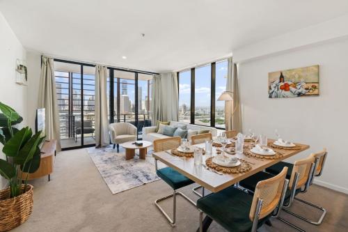 a dining room with a table and chairs and a living room at Unbeatable River and CBD Views Pool 2Car and Prime Spot in Brisbane
