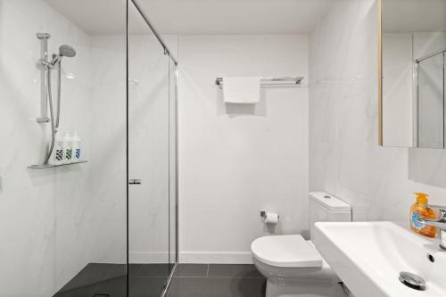 a bathroom with a shower and a toilet and a sink at Unbeatable River and CBD Views Pool 2Car and Prime Spot in Brisbane