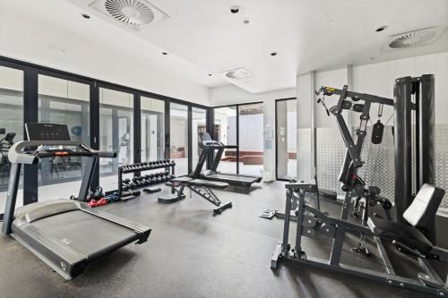 a gym with several treadmills and elliptical machines at Unbeatable River and CBD Views Pool 2Car and Prime Spot in Brisbane