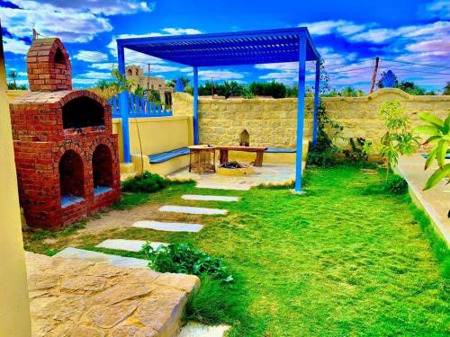 a backyard with a brick oven and a picnic table at شمس تونس in Tunis