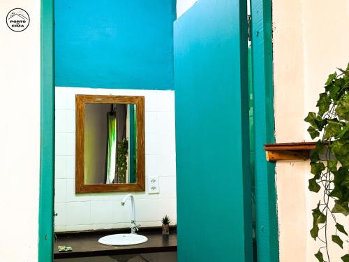 a bathroom with a mirror and a sink at Casas Porto de Cima in Morro de São Paulo