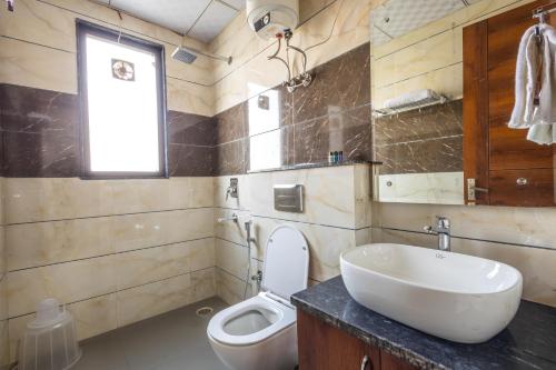 a bathroom with a sink and a toilet at Hotel Gill Comfort Inn - Close to MEDANTA, ARTEMIS AND FORTIS HOSPITAL in Gurgaon
