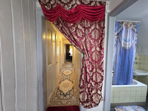 a doorway to a bathroom with a red curtain at Villa de Maître in Bern in Bern
