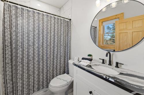 a bathroom with a toilet and a sink and a mirror at Lorien in Fleetwood