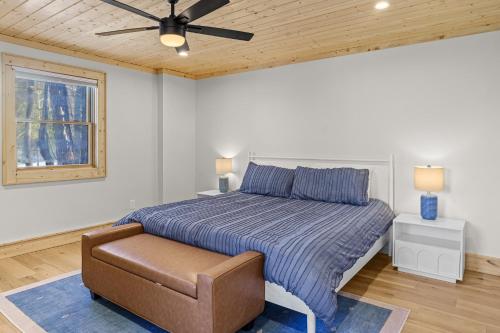 a bedroom with a bed and a ceiling fan at Lorien in Fleetwood