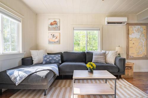 a living room with a couch and a table at Relaxing Farm Retreat- Fresh Eggs with Every Stay! in Gig Harbor