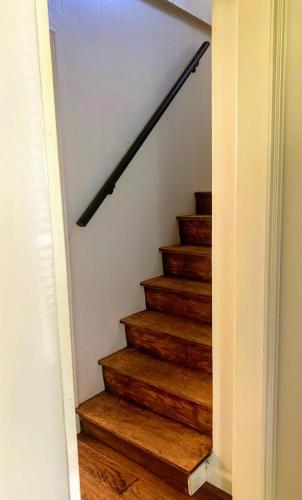 a stairway with wooden stairs with a railing at Relaxing Farm Retreat- Fresh Eggs with Every Stay! in Gig Harbor