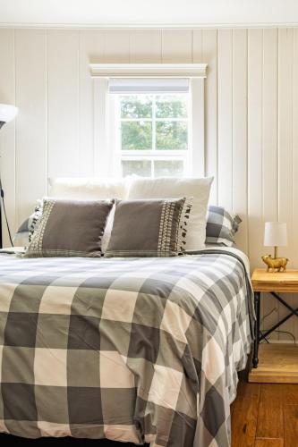a bedroom with a bed with a plaid blanket at Relaxing Farm Retreat- Fresh Eggs with Every Stay! in Gig Harbor