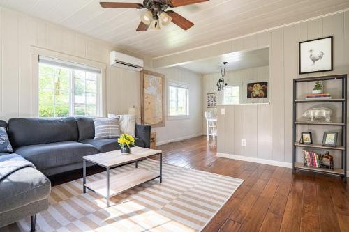a living room with a couch and a table at Relaxing Farm Retreat- Fresh Eggs with Every Stay! in Gig Harbor