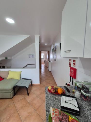 a living room with a couch and a table at A Caminho da Ilha in Ponta Delgada
