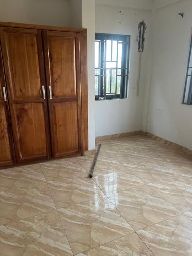 an empty room with a mop on the floor at Trinity Apartment in Ofankor