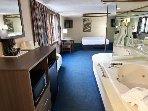 a hotel room with a sink and a bathroom at Sidney James Mountain Lodge in Gatlinburg