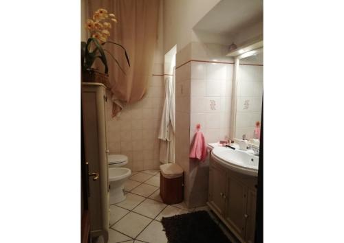 a bathroom with a toilet and a sink at Momenti Suite in Piombino
