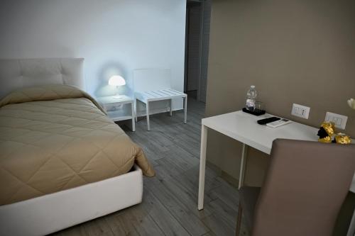 a bedroom with a bed and a desk and a desk at B&B Diana in Piazza Armerina