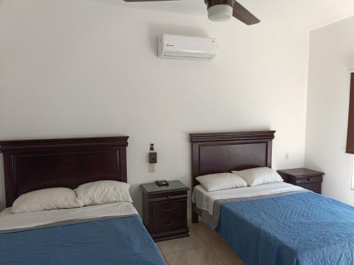 two beds sitting next to each other in a bedroom at Posada don rulo in Mazatlán