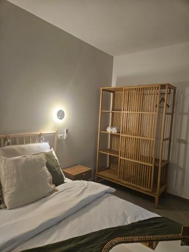 a bedroom with a bed and a book shelf at קציר ריזורט in Migdal