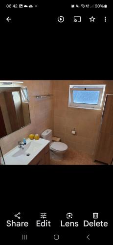 a bathroom with a sink and a toilet and a window at Villa Feliza in Güime