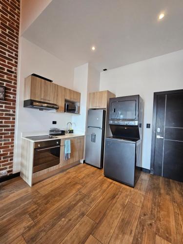 a kitchen with a refrigerator and a tv in it at Apartamento 1108 con la mejor vista del Centro Histórico in Las Victorias