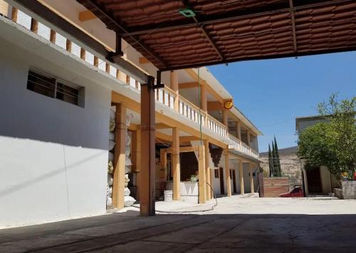 an outside view of a building with a porch at Hotel Casa Eduardo Martinez in Santiago Matatlán